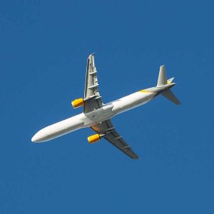 Airplane in blue cloudless sky