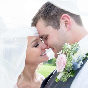 newly wed couple under veil